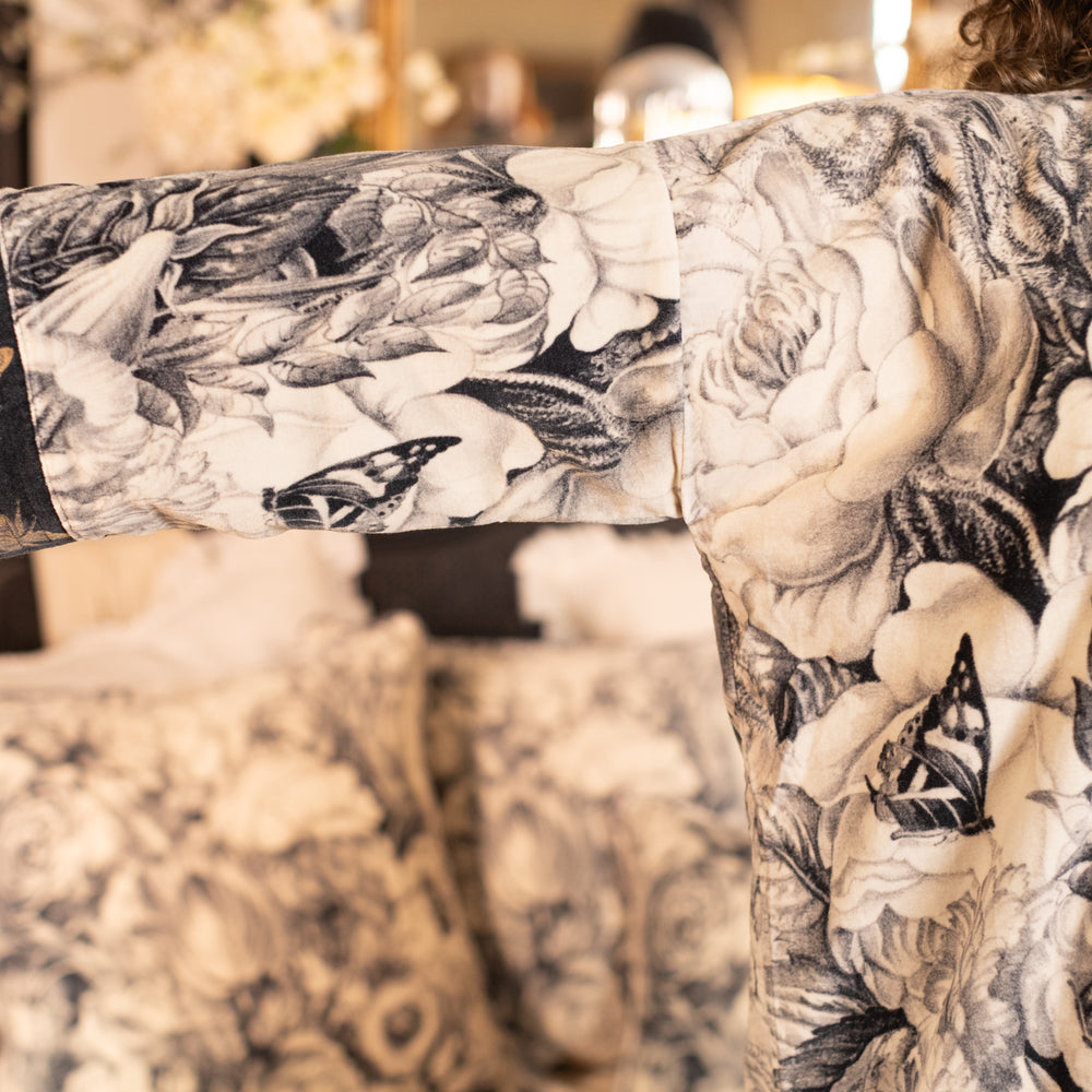 
                  
                    Model wearing a soft cotton velvet duster ft. 1900's floral lithographs. A garden dreamt up in ink - Market of Stars
                  
                