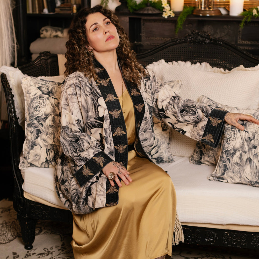 
                  
                    Model wearing a soft cotton velvet duster ft. 1900's floral lithographs. A garden dreamt up in ink - Market of Stars
                  
                