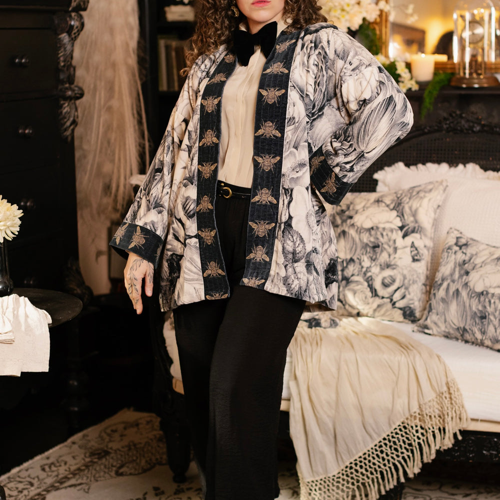 
                  
                    Model wearing a soft cotton velvet duster ft. 1900's floral lithographs. A garden dreamt up in ink - Market of Stars
                  
                