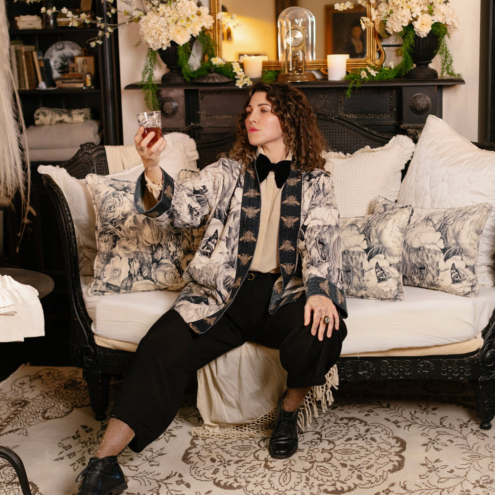 
                  
                    Model wearing a soft cotton velvet duster ft. 1900's floral lithographs. A garden dreamt up in ink - Market of Stars
                  
                