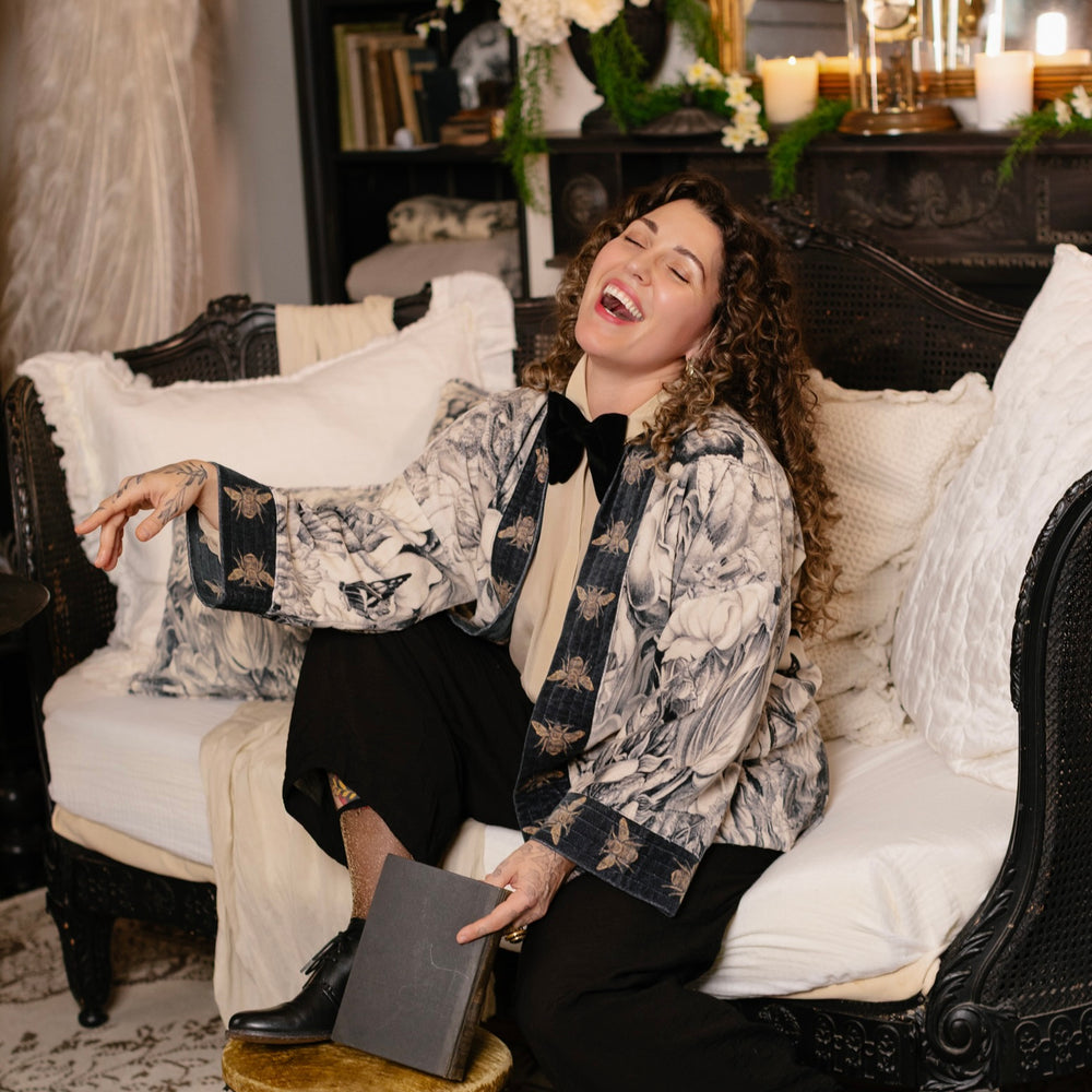 
                  
                    Model wearing a soft cotton velvet duster ft. 1900's floral lithographs. A garden dreamt up in ink - Market of Stars
                  
                