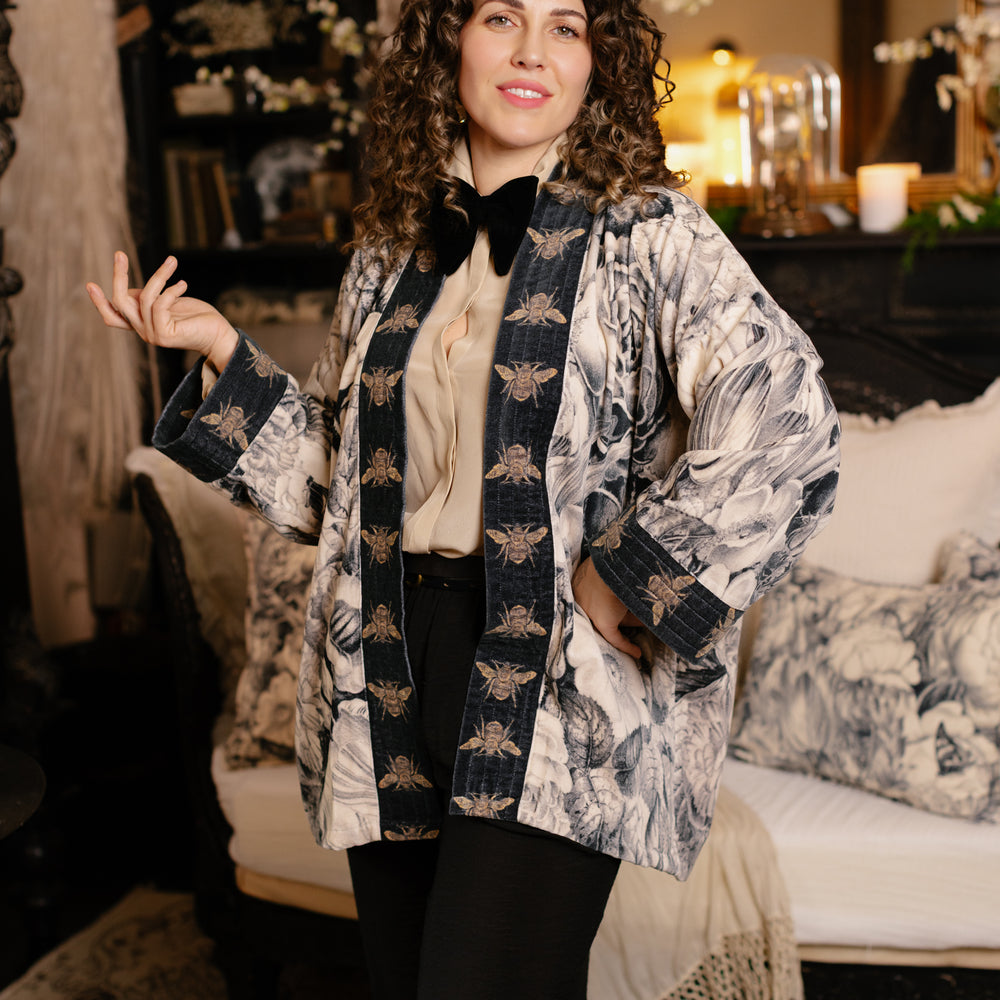 
                  
                    Model wearing a soft cotton velvet duster ft. 1900's floral lithographs. A garden dreamt up in ink - Market of Stars
                  
                