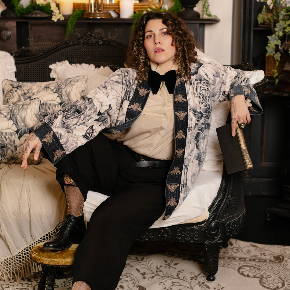 
                  
                    Model wearing a soft cotton velvet duster ft. 1900's floral lithographs. A garden dreamt up in ink - Market of Stars
                  
                