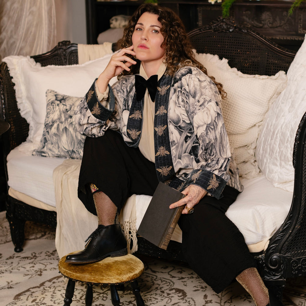 
                  
                    Model wearing a soft cotton velvet duster ft. 1900's floral lithographs. A garden dreamt up in ink - Market of Stars
                  
                