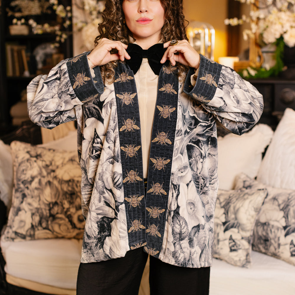 
                  
                    Model wearing a soft cotton velvet duster ft. 1900's floral lithographs. A garden dreamt up in ink - Market of Stars
                  
                