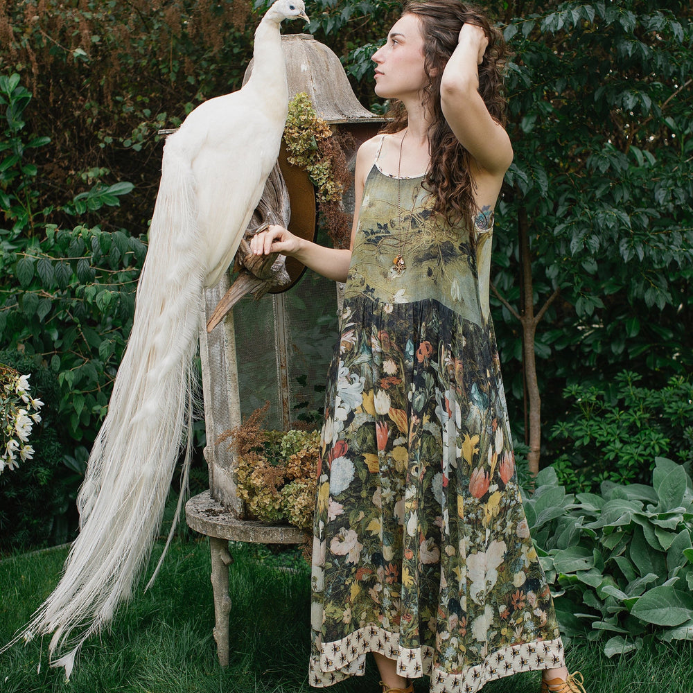 Model wearing the I Dream in Flowers Bohéme Slip Dress with vintage-inspired floral artwork and Victorian bumblebee details, perfect for layering or lounging – Market of Stars.