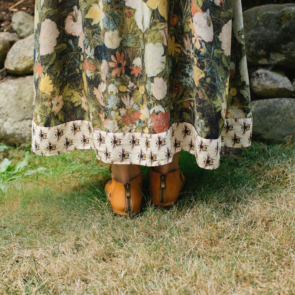 Model wearing the I Dream in Flowers Bohéme Slip Dress with vintage-inspired floral artwork and Victorian bumblebee details, perfect for layering or lounging – Market of Stars.