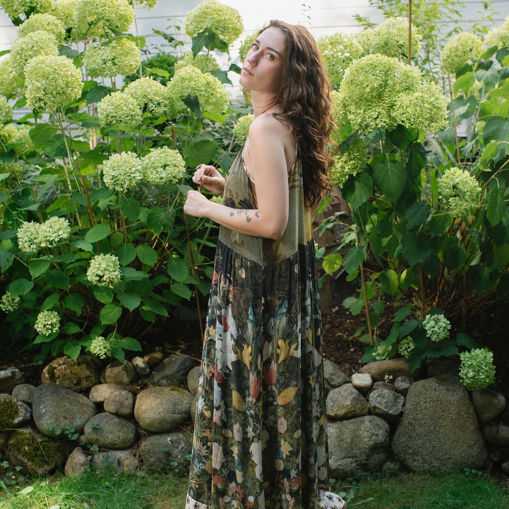 
                  
                    Model wearing the I Dream in Flowers Bohéme Slip Dress with vintage-inspired floral artwork and Victorian bumblebee details, perfect for layering or lounging – Market of Stars.
                  
                