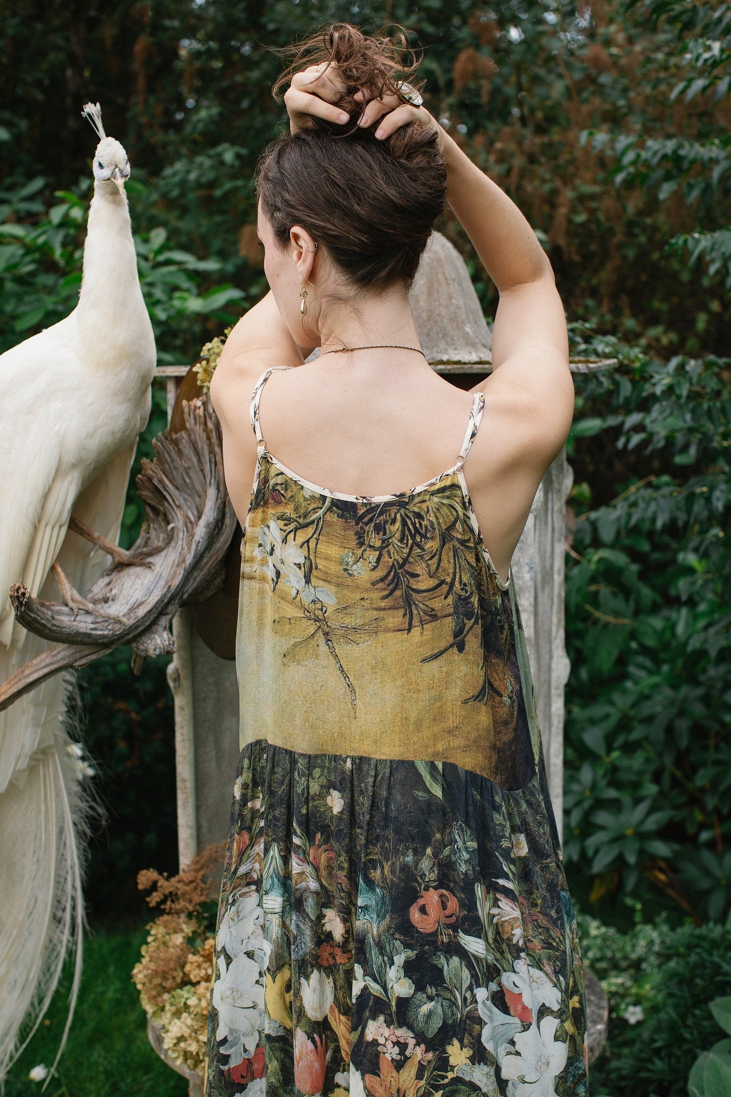 Model wearing the I Dream in Flowers Bohéme Slip Dress with vintage-inspired floral artwork and Victorian bumblebee details, perfect for layering or lounging – Market of Stars.