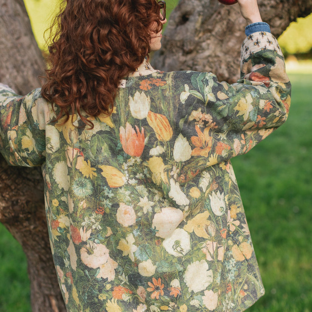 Model wearing the I Dream in Flowers Cottage Cardigan featuring painterly floral artwork and Victorian bumblebee trim, perfect for cozy layering – Market of Stars