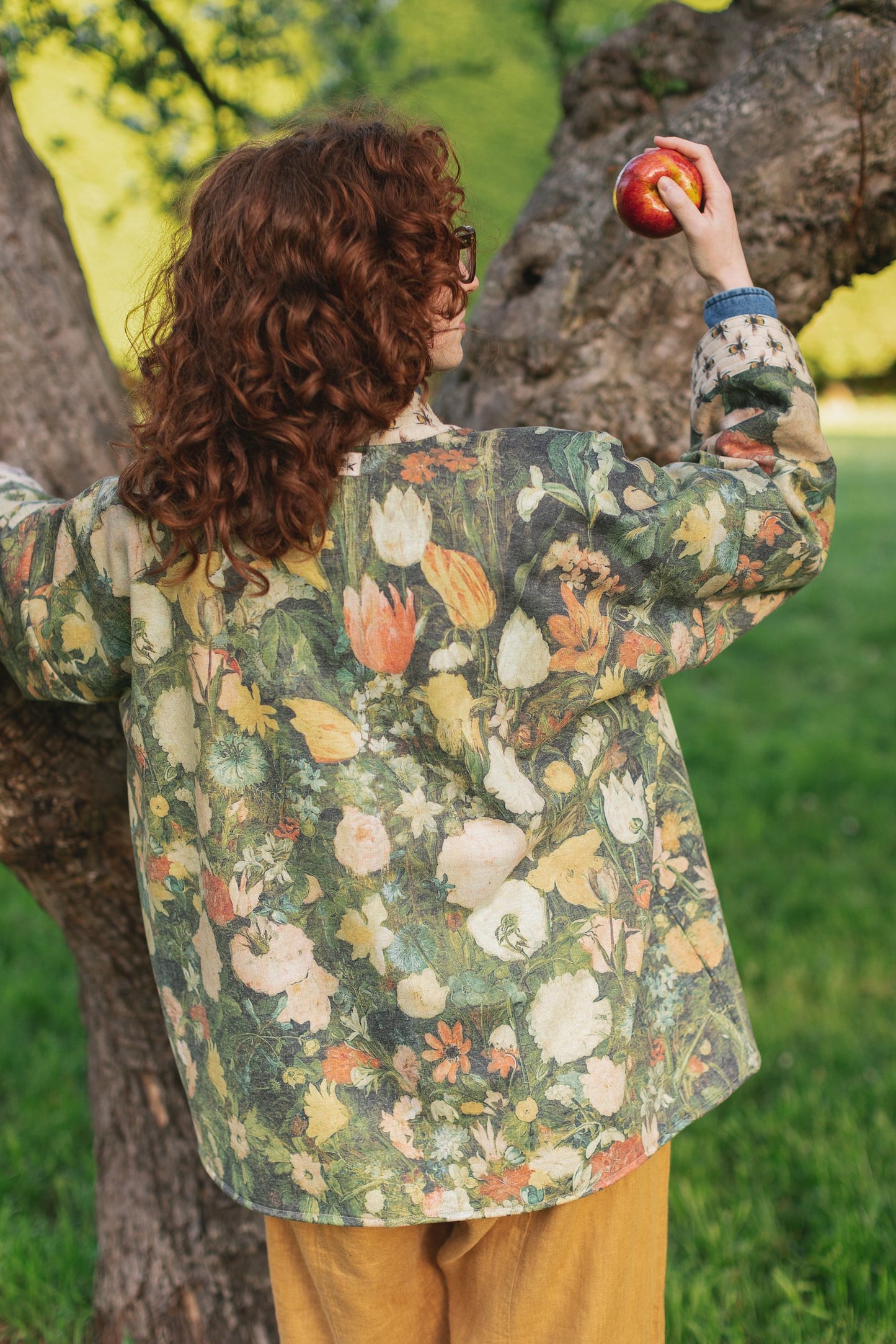 Model wearing the I Dream in Flowers Cottage Cardigan featuring painterly floral artwork and Victorian bumblebee trim, perfect for cozy layering – Market of Stars