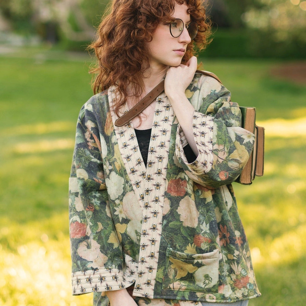 Model wearing the I Dream in Flowers Cottage Cardigan featuring painterly floral artwork and Victorian bumblebee trim, perfect for cozy layering – Market of Stars