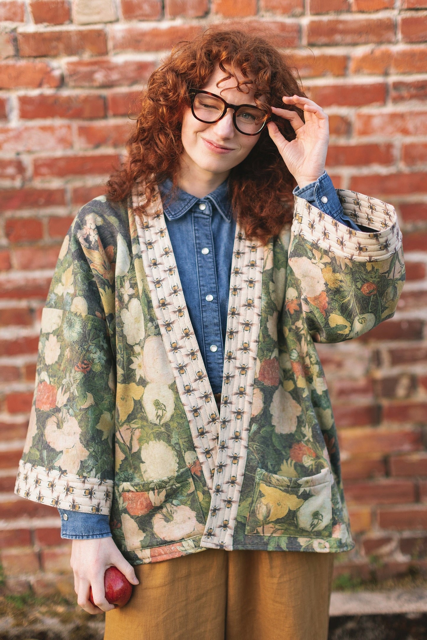 Model wearing the I Dream in Flowers Cottage Cardigan featuring painterly floral artwork and Victorian bumblebee trim, perfect for cozy layering – Market of Stars