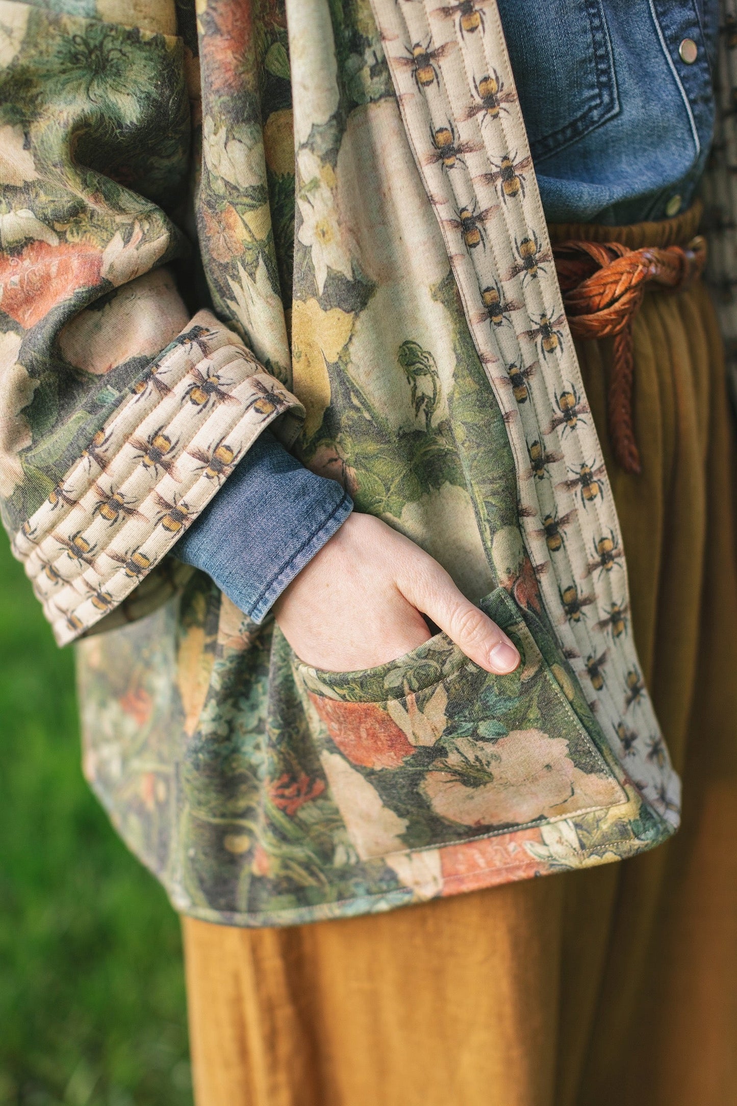 Model wearing the I Dream in Flowers Cottage Cardigan featuring painterly floral artwork and Victorian bumblebee trim, perfect for cozy layering – Market of Stars