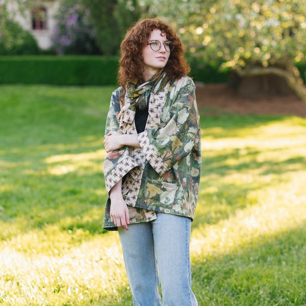 
                  
                    Model wearing the I Dream in Flowers Cottage Cardigan featuring painterly floral artwork and Victorian bumblebee trim, perfect for cozy layering – Market of Stars
                  
                