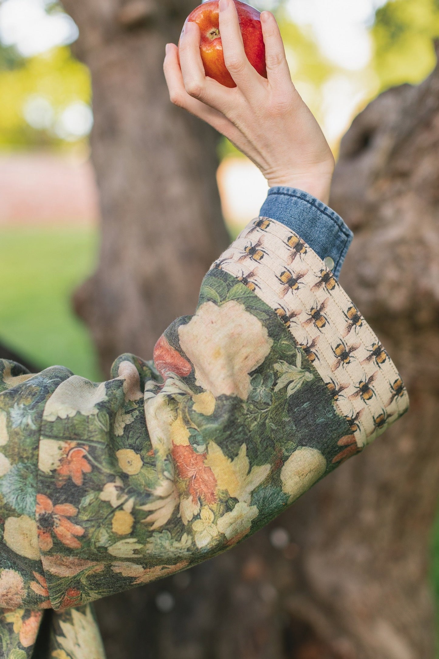 Model wearing the I Dream in Flowers Cottage Cardigan featuring painterly floral artwork and Victorian bumblebee trim, perfect for cozy layering – Market of Stars