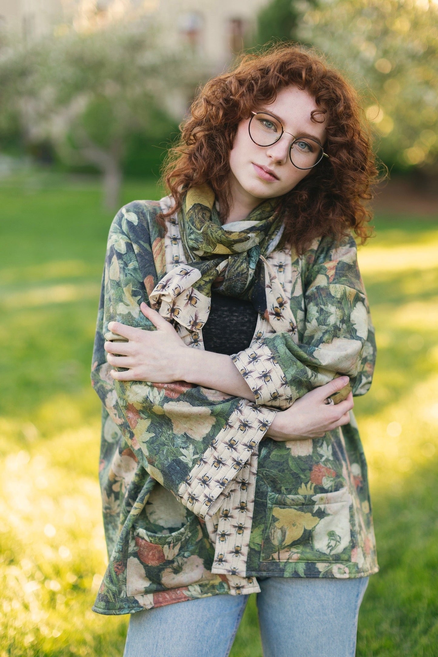 Model wearing the I Dream in Flowers Cottage Cardigan featuring painterly floral artwork and Victorian bumblebee trim, perfect for cozy layering – Market of Stars