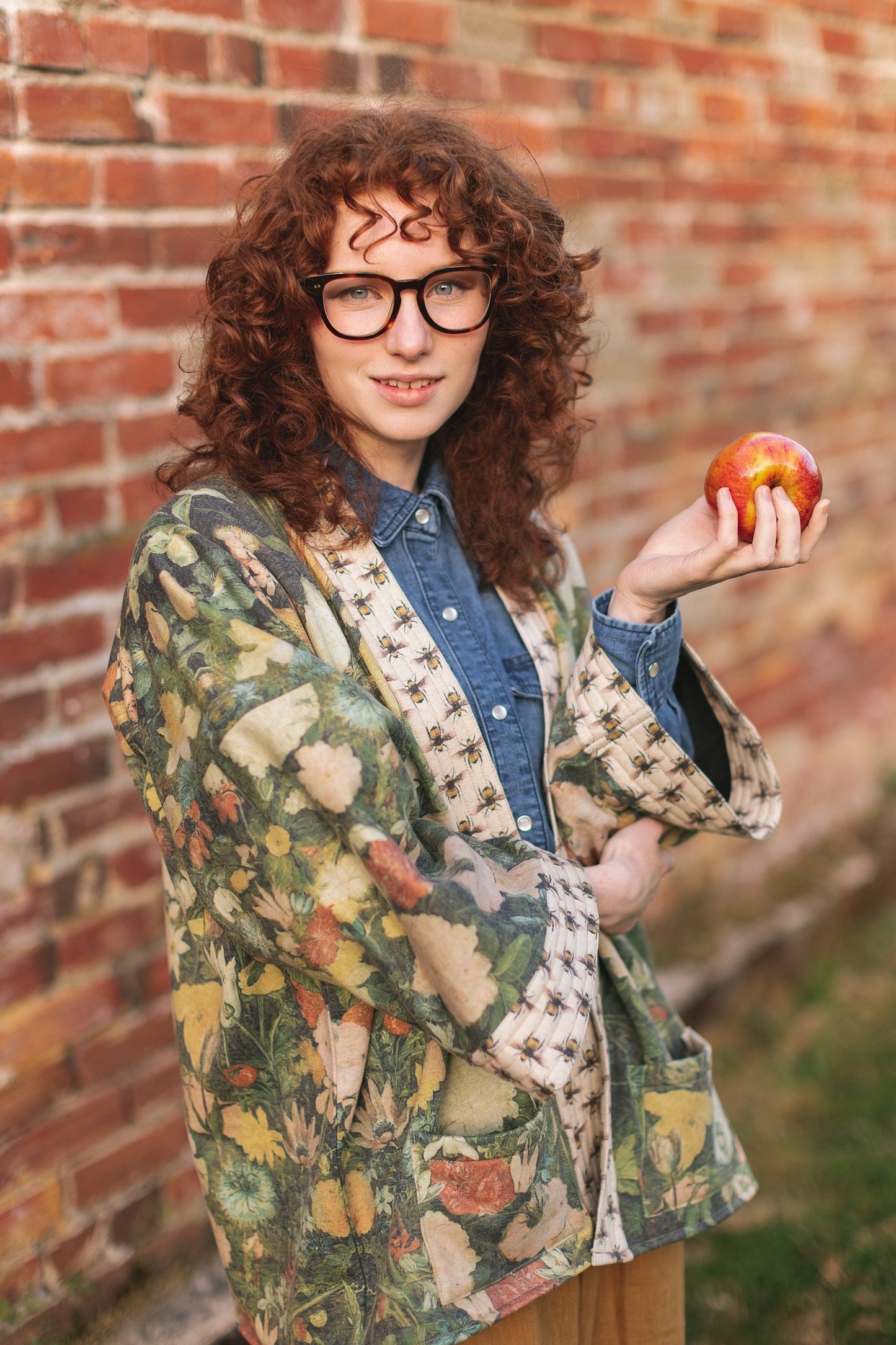 Model wearing the I Dream in Flowers Cottage Cardigan featuring painterly floral artwork and Victorian bumblebee trim, perfect for cozy layering – Market of Stars