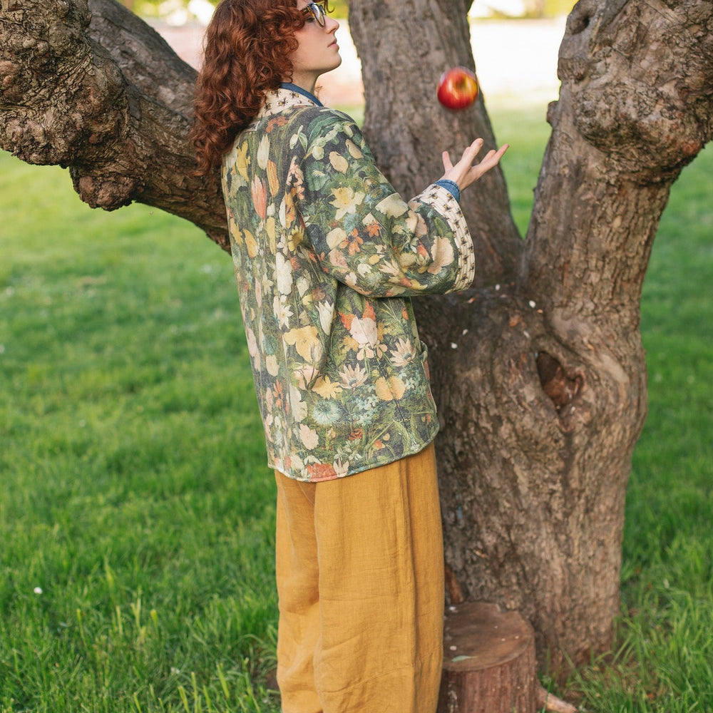 
                  
                    Model wearing the I Dream in Flowers Cottage Cardigan featuring painterly floral artwork and Victorian bumblebee trim, perfect for cozy layering – Market of Stars
                  
                