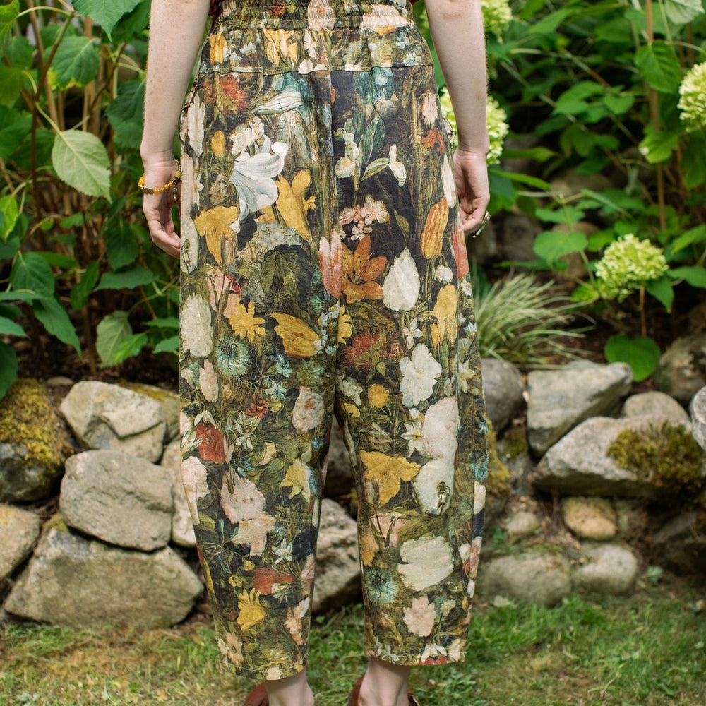 
                  
                    Model wearing the I Dream in Flowers Artist Pants featuring romantic floral artwork by Jan Brueghel and Victorian bumblebee trim, styled for everyday ease – Market of Stars
                  
                
