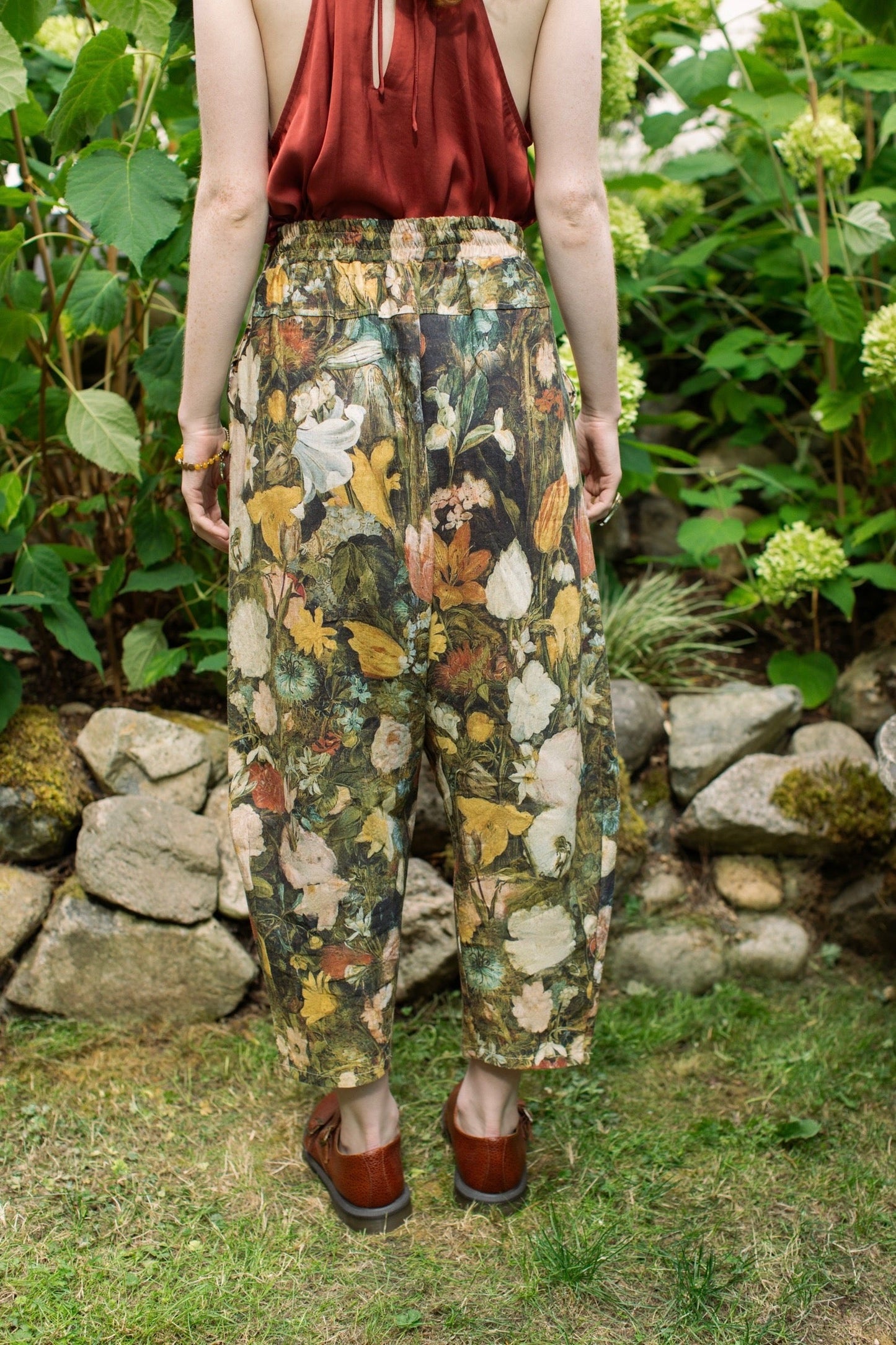 Model wearing the I Dream in Flowers Artist Pants featuring romantic floral artwork by Jan Brueghel and Victorian bumblebee trim, styled for everyday ease – Market of Stars