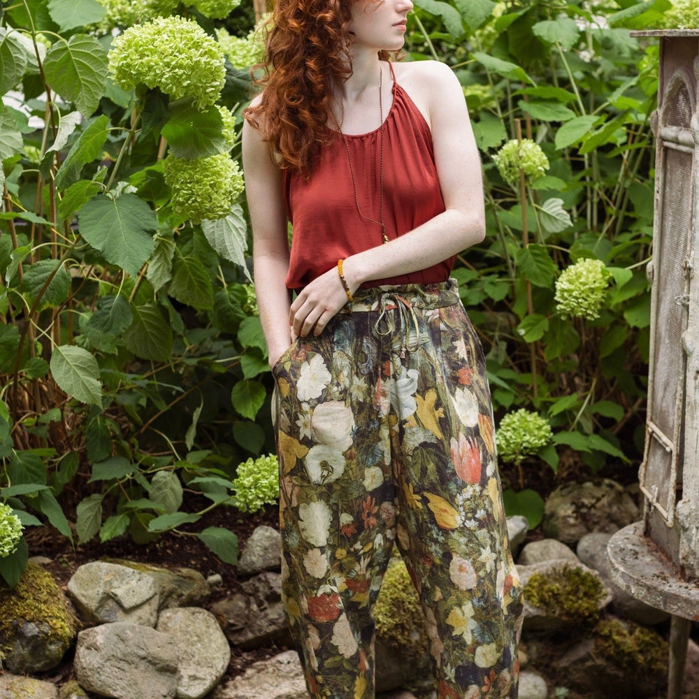 
                  
                    Model wearing the I Dream in Flowers Artist Pants featuring romantic floral artwork by Jan Brueghel and Victorian bumblebee trim, styled for everyday ease – Market of Stars
                  
                