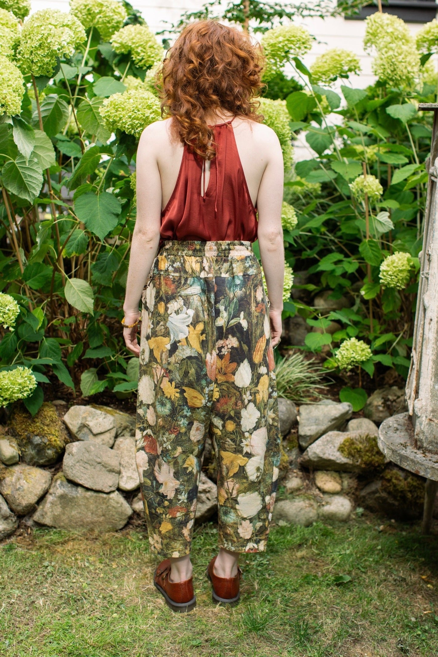 Model wearing the I Dream in Flowers Artist Pants featuring romantic floral artwork by Jan Brueghel and Victorian bumblebee trim, styled for everyday ease – Market of Stars