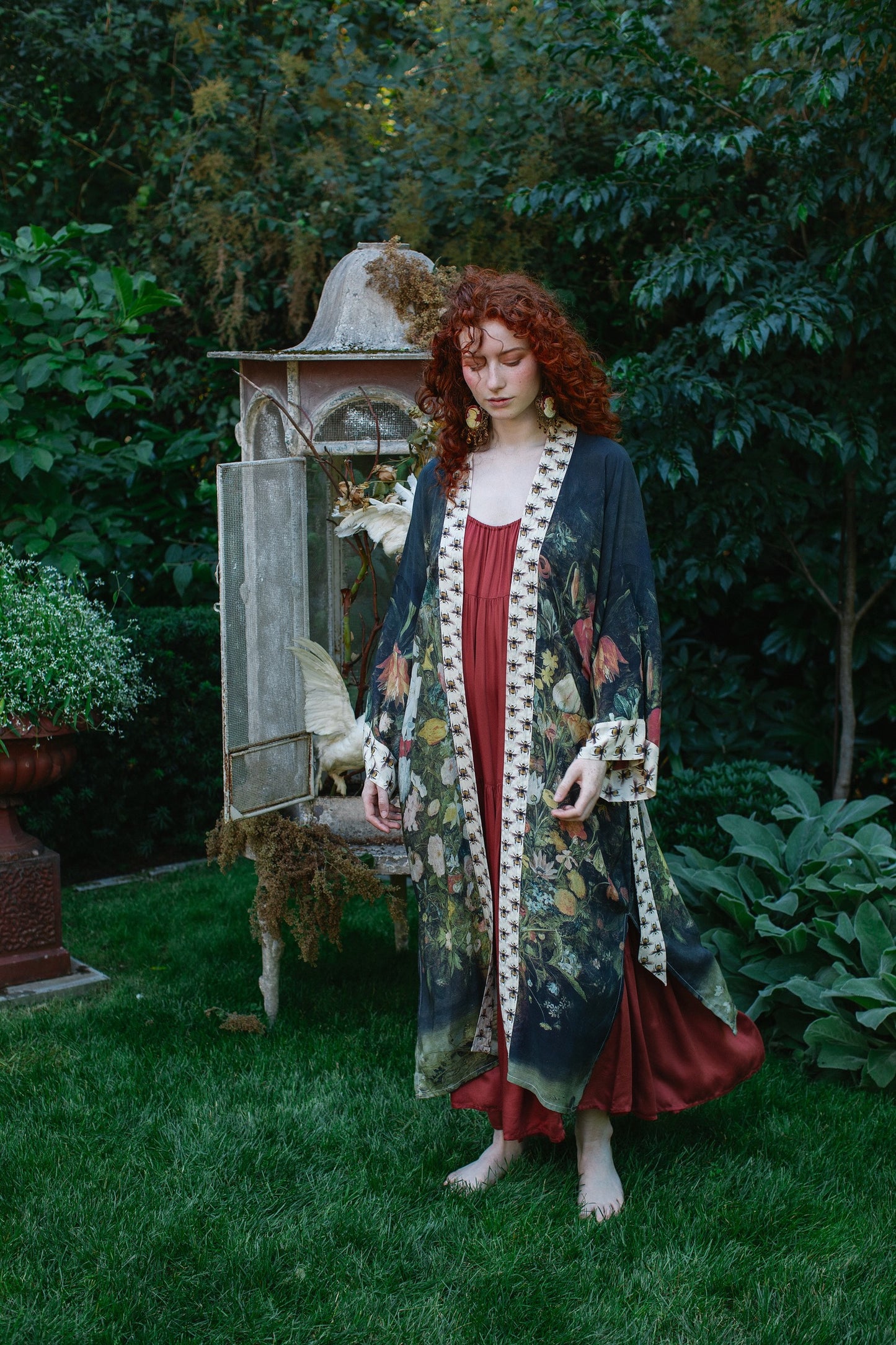 Model wearing the I Dream in Flowers Opera Duster featuring floral oil painting by Jan Brueghel and Victorian bumblebee trim – Market of Stars.