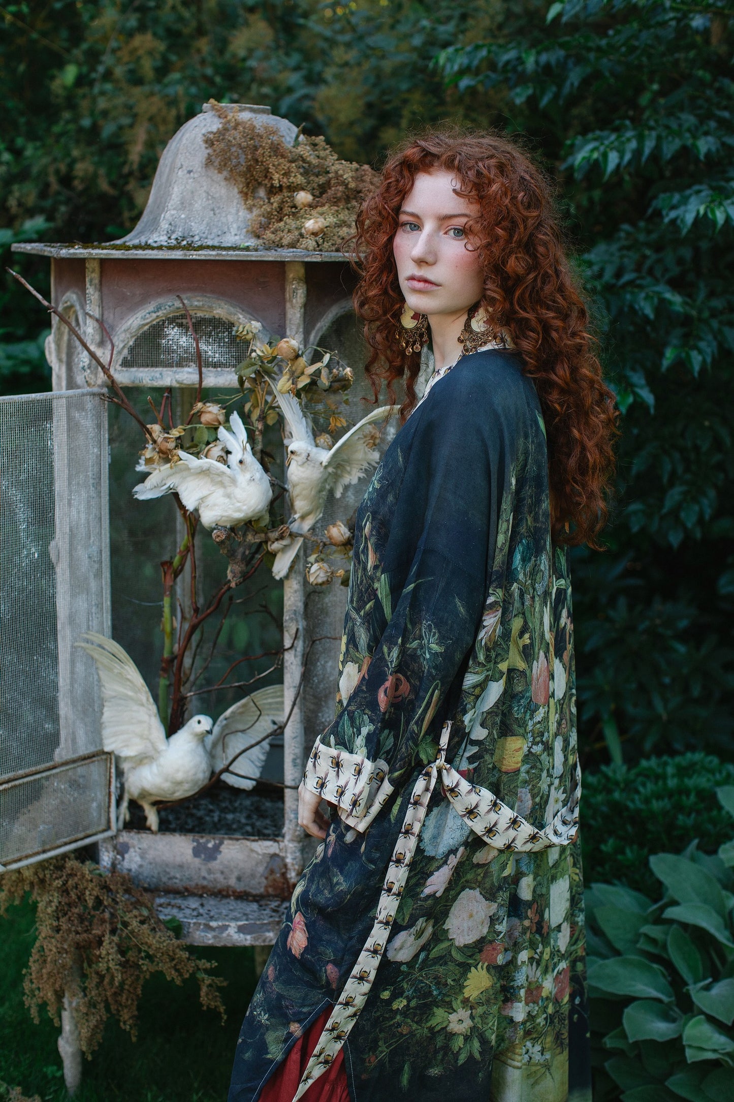 Model wearing the I Dream in Flowers Opera Duster featuring floral oil painting by Jan Brueghel and Victorian bumblebee trim – Market of Stars.