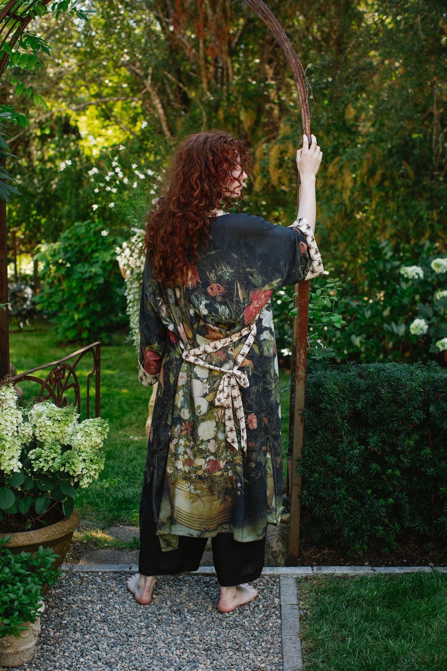 Model wearing the I Dream in Flowers Opera Duster featuring floral oil painting by Jan Brueghel and Victorian bumblebee trim – Market of Stars.