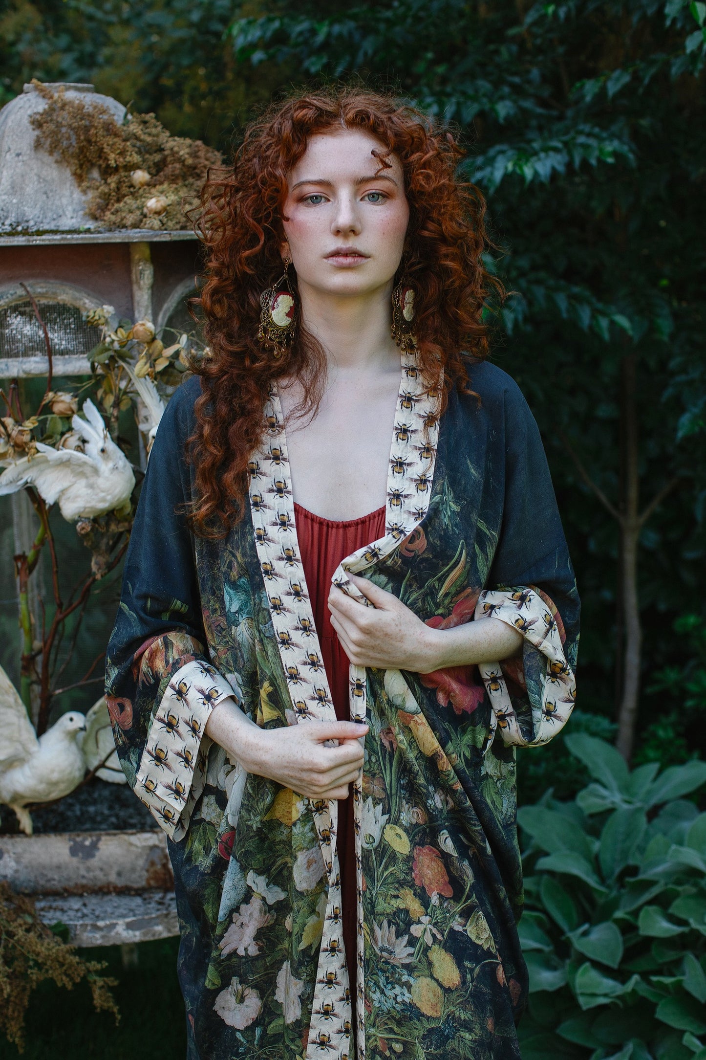 Model wearing the I Dream in Flowers Opera Duster featuring floral oil painting by Jan Brueghel and Victorian bumblebee trim – Market of Stars.