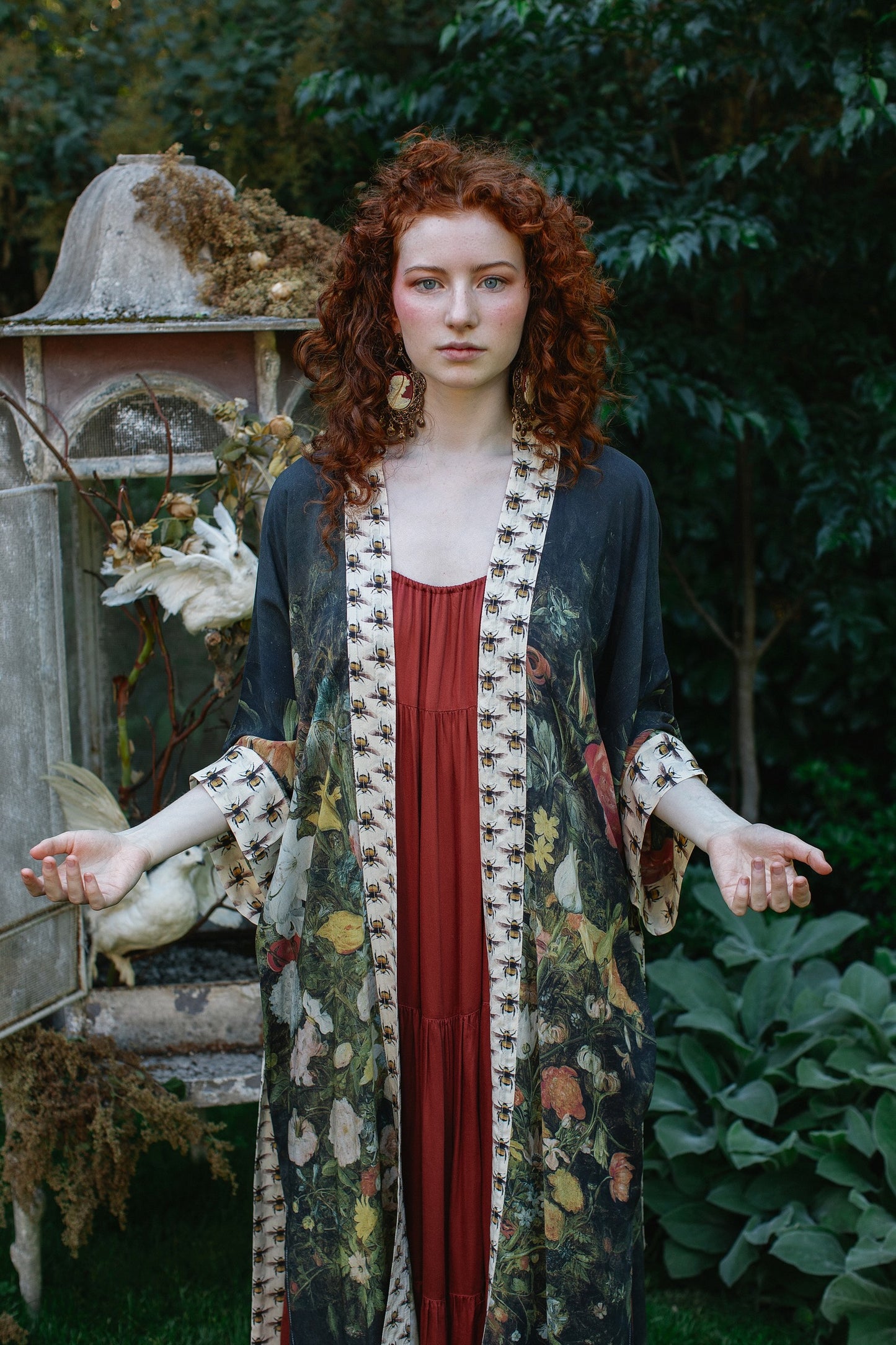 Model wearing the I Dream in Flowers Opera Duster featuring floral oil painting by Jan Brueghel and Victorian bumblebee trim – Market of Stars.