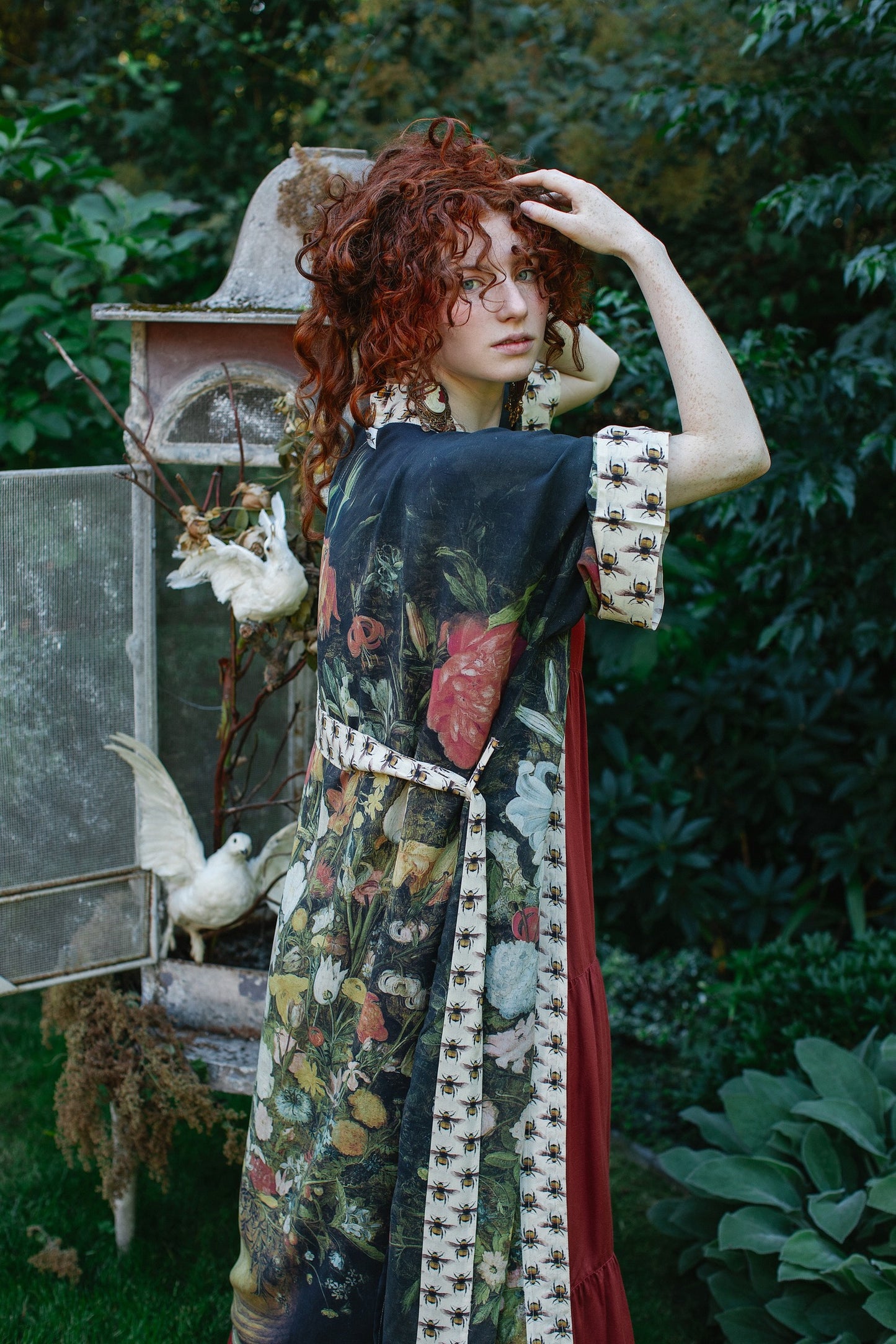 Model wearing the I Dream in Flowers Opera Duster featuring floral oil painting by Jan Brueghel and Victorian bumblebee trim – Market of Stars.
