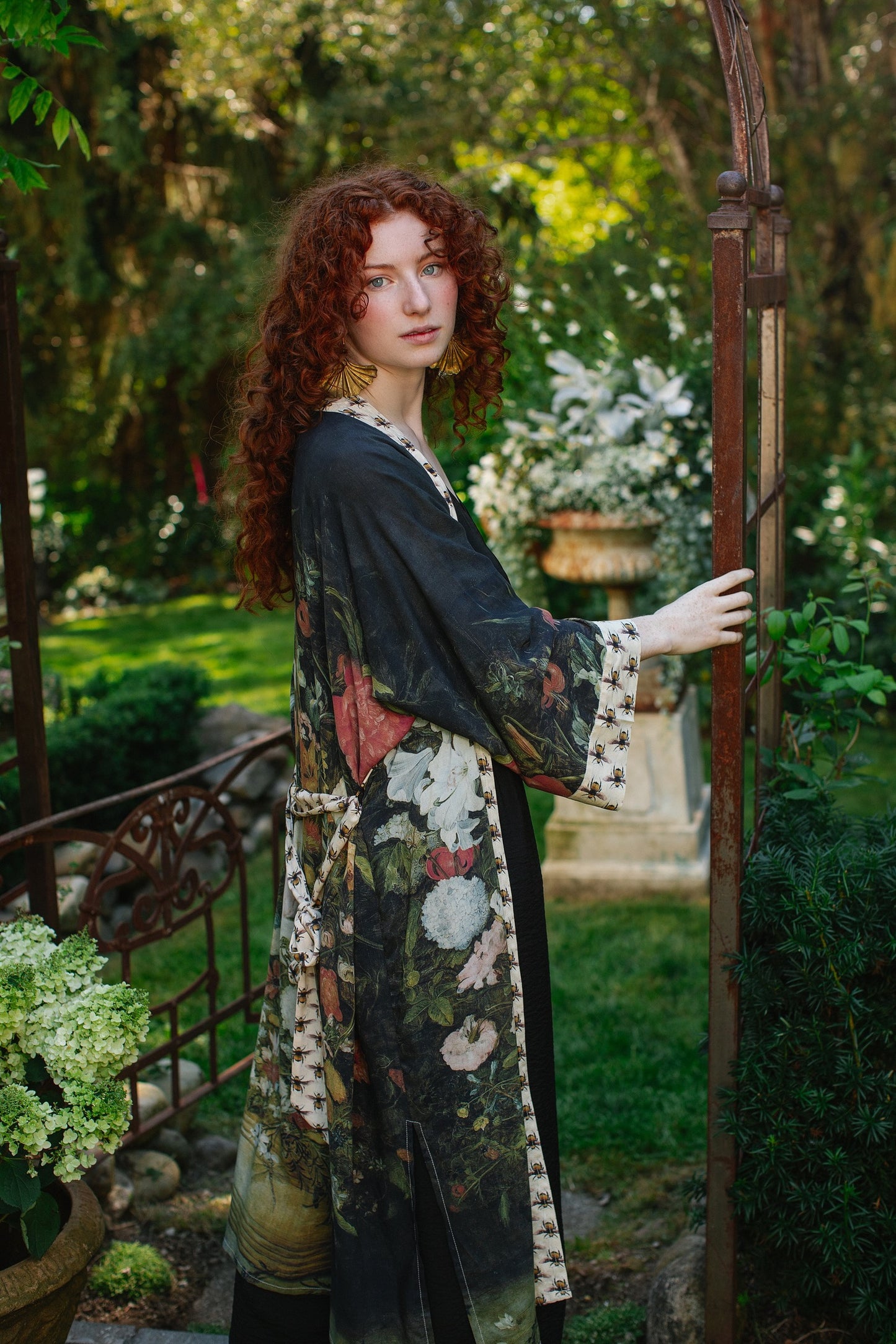 Model wearing the I Dream in Flowers Opera Duster featuring floral oil painting by Jan Brueghel and Victorian bumblebee trim – Market of Stars.