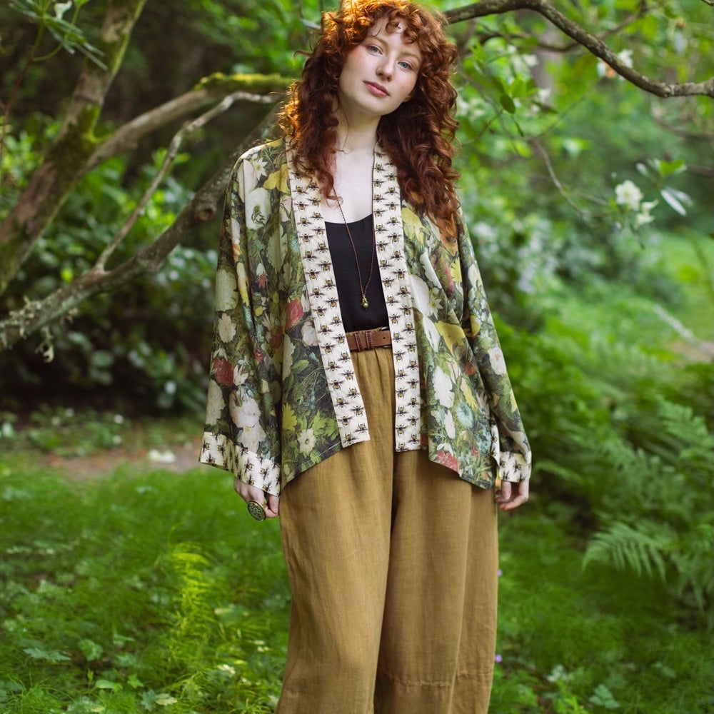 
                  
                    Model wearing the I Dream in Flowers cropped kimono featuring romantic floral artwork by Jan Brueghel and Victorian bumblebee trim – Market of Stars.
                  
                