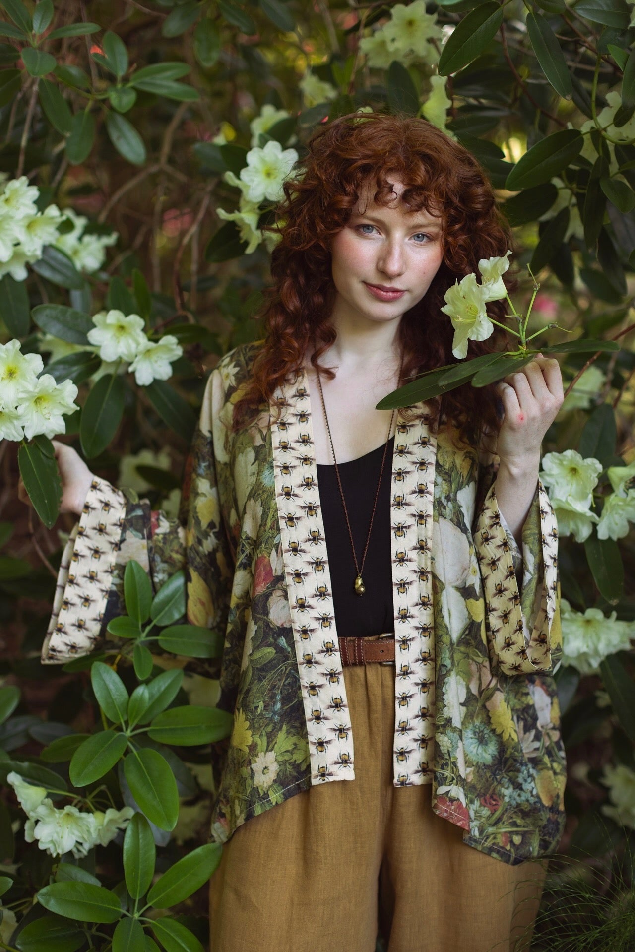 Model wearing the I Dream in Flowers cropped kimono featuring romantic floral artwork by Jan Brueghel and Victorian bumblebee trim – Market of Stars.