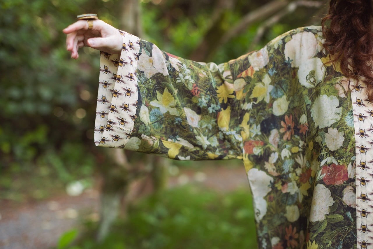 Model wearing the I Dream in Flowers cropped kimono featuring romantic floral artwork by Jan Brueghel and Victorian bumblebee trim – Market of Stars.