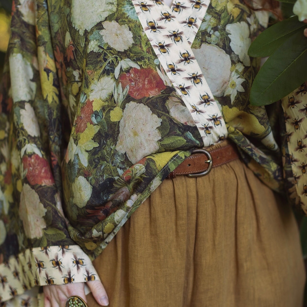
                  
                    Model wearing the I Dream in Flowers cropped kimono featuring romantic floral artwork by Jan Brueghel and Victorian bumblebee trim – Market of Stars.
                  
                