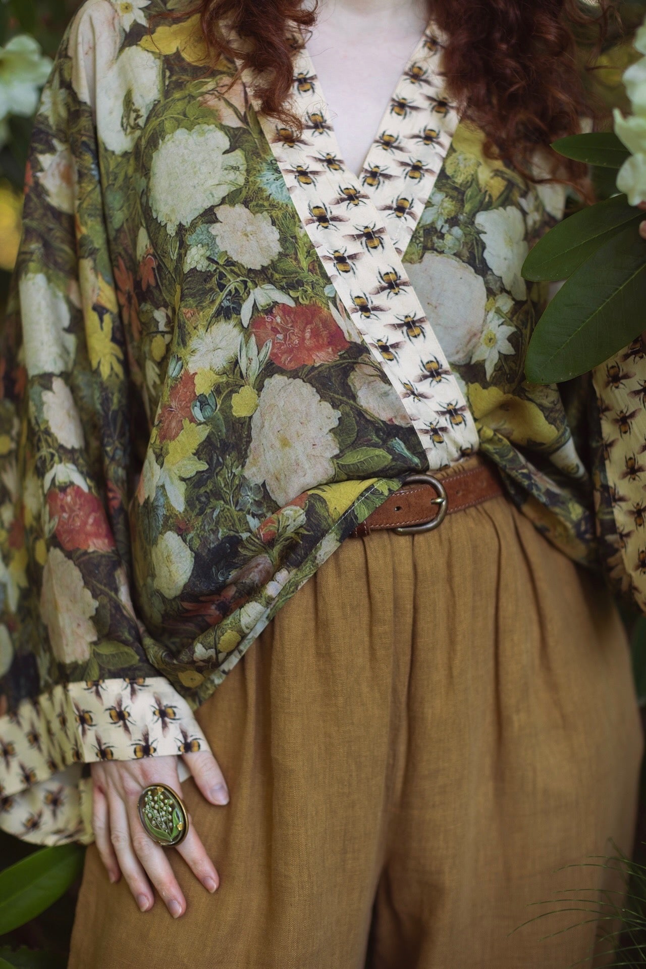 Model wearing the I Dream in Flowers cropped kimono featuring romantic floral artwork by Jan Brueghel and Victorian bumblebee trim – Market of Stars.