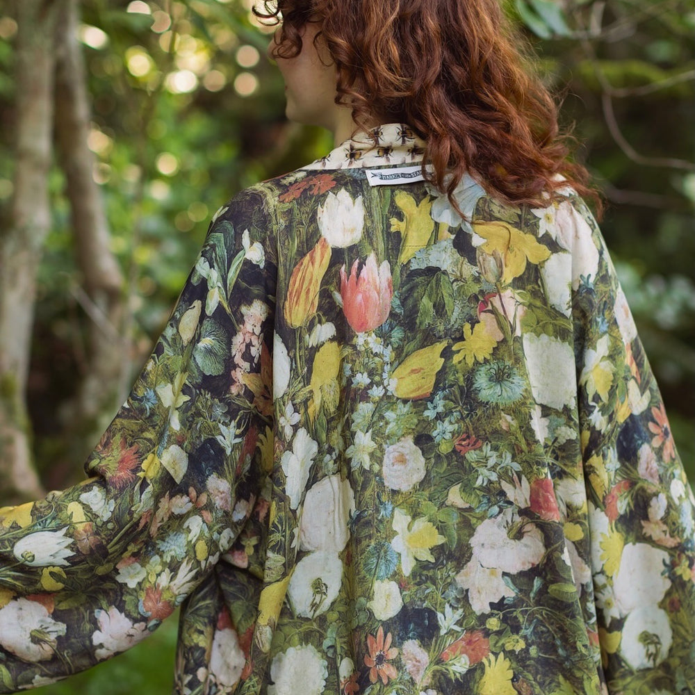 
                  
                    Model wearing the I Dream in Flowers cropped kimono featuring romantic floral artwork by Jan Brueghel and Victorian bumblebee trim – Market of Stars.
                  
                