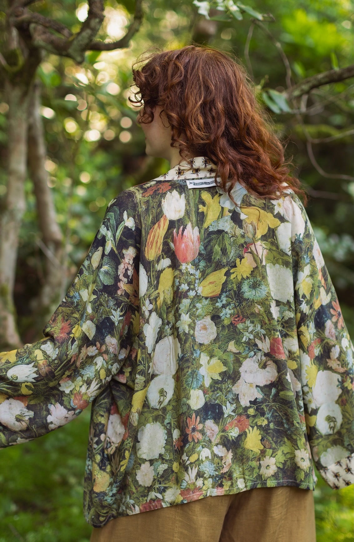 Model wearing the I Dream in Flowers cropped kimono featuring romantic floral artwork by Jan Brueghel and Victorian bumblebee trim – Market of Stars.