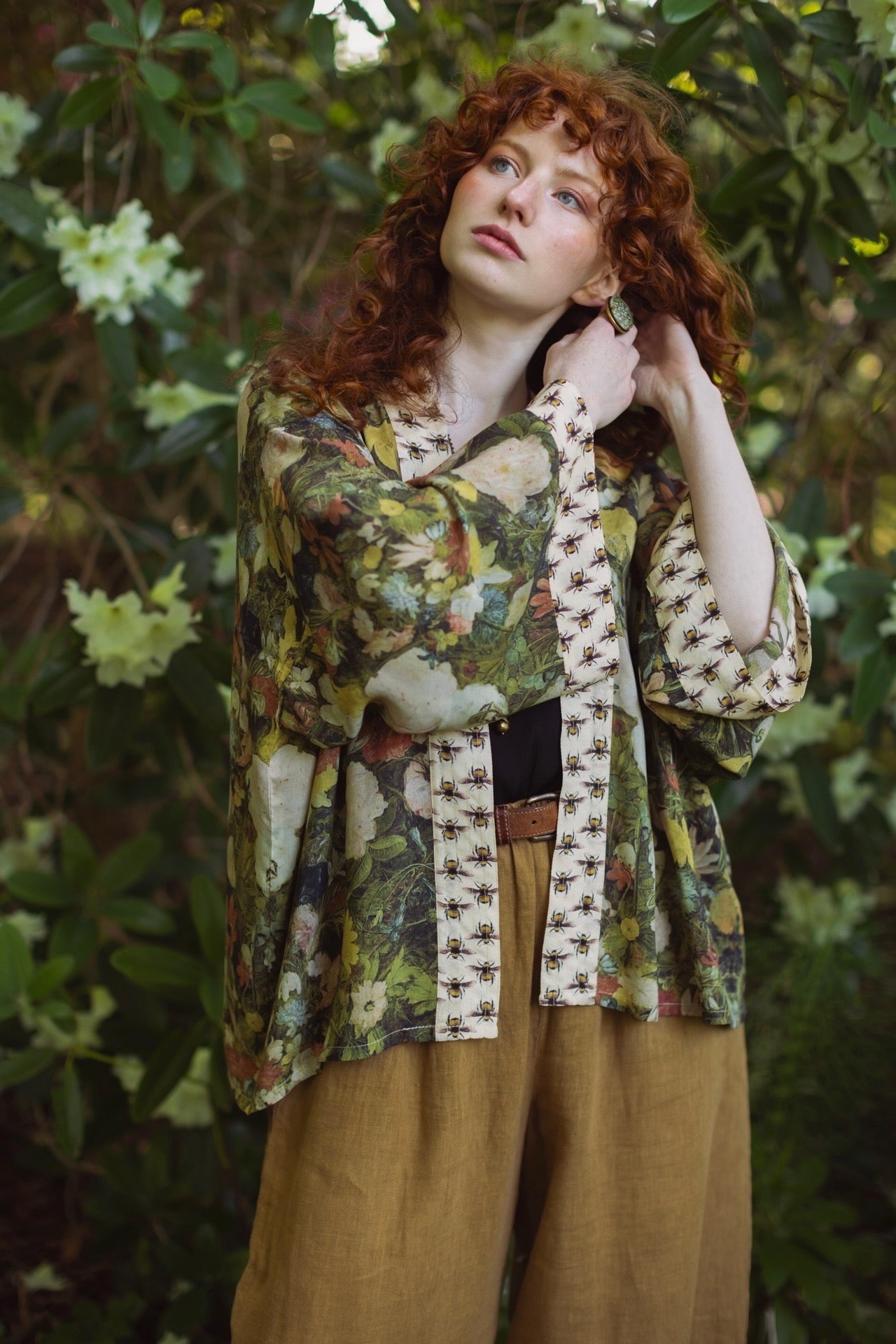 Model wearing the I Dream in Flowers cropped kimono featuring romantic floral artwork by Jan Brueghel and Victorian bumblebee trim – Market of Stars.