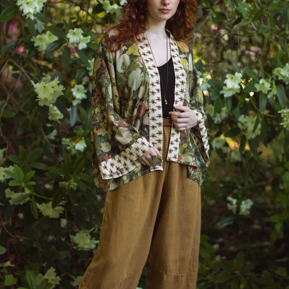 
                  
                    Model wearing the I Dream in Flowers cropped kimono featuring romantic floral artwork by Jan Brueghel and Victorian bumblebee trim – Market of Stars.
                  
                
