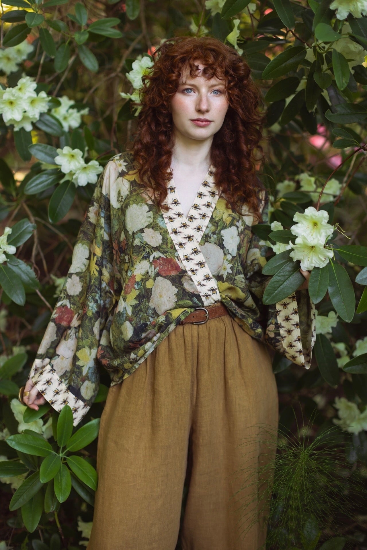 Model wearing the I Dream in Flowers cropped kimono featuring romantic floral artwork by Jan Brueghel and Victorian bumblebee trim – Market of Stars.
