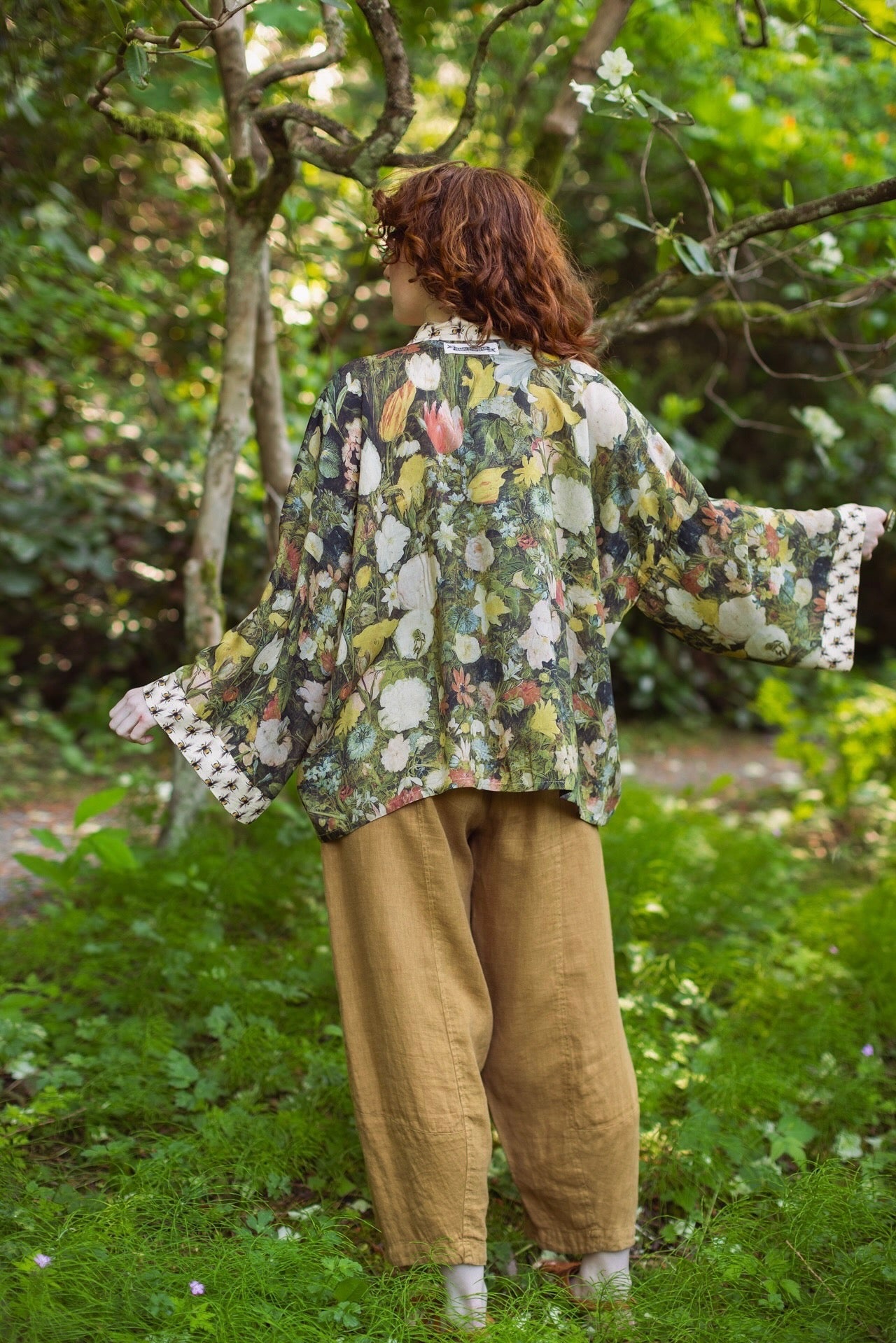 Model wearing the I Dream in Flowers cropped kimono featuring romantic floral artwork by Jan Brueghel and Victorian bumblebee trim – Market of Stars.