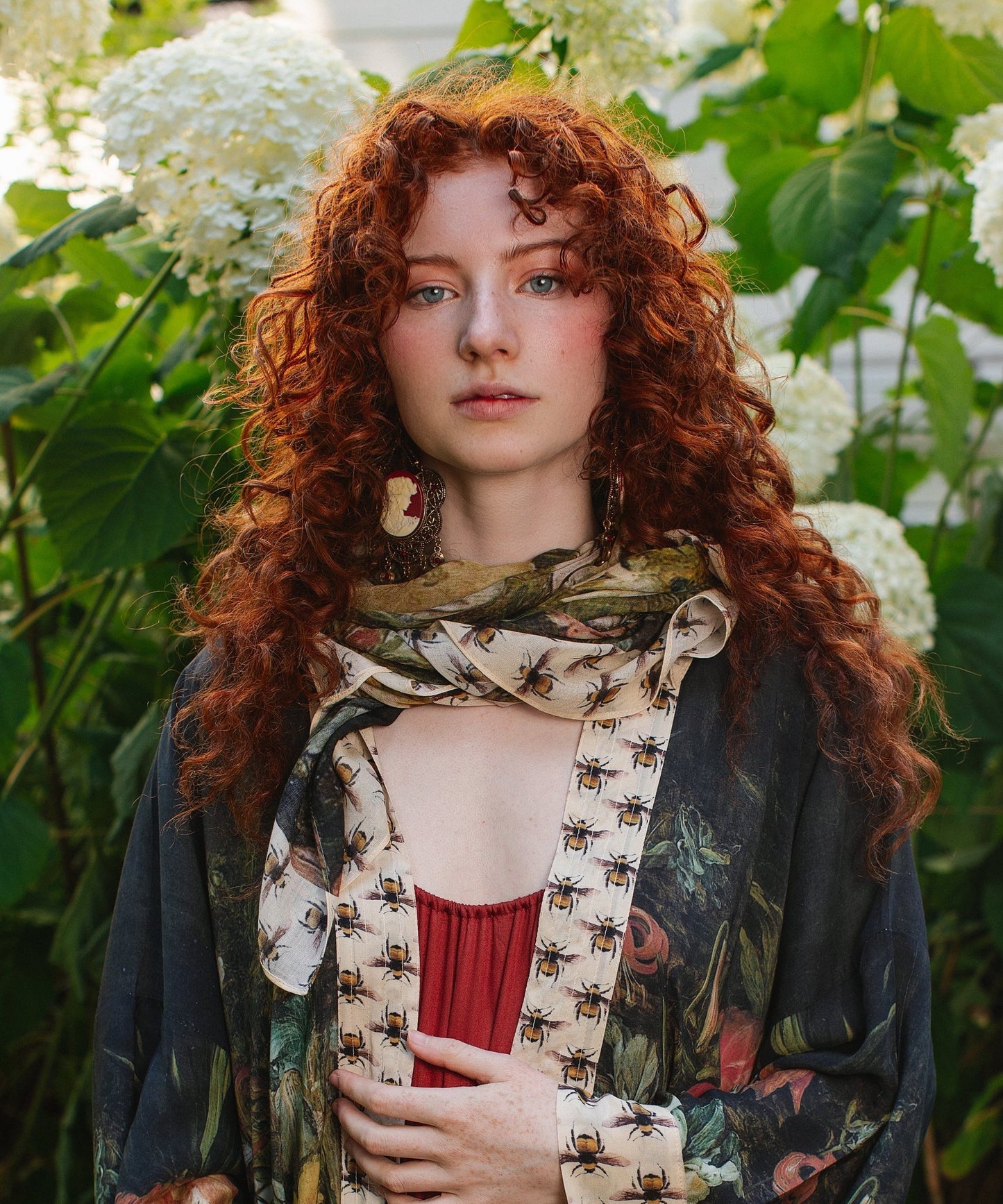 Model wearing the I Dream in Flowers Scarf featuring lush floral art by Jan Brueghel and charming Victorian bumblebees – Market of Stars.