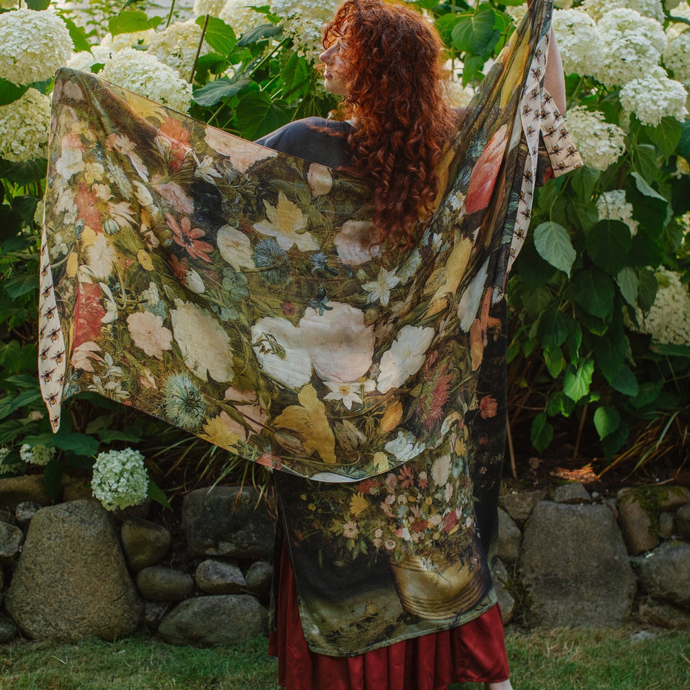 Model wearing the I Dream in Flowers Scarf featuring lush floral art by Jan Brueghel and charming Victorian bumblebees – Market of Stars.