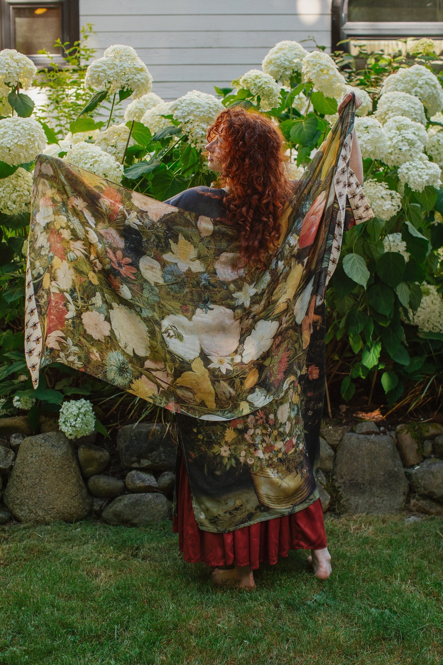 Model wearing the I Dream in Flowers Scarf featuring lush floral art by Jan Brueghel and charming Victorian bumblebees – Market of Stars.