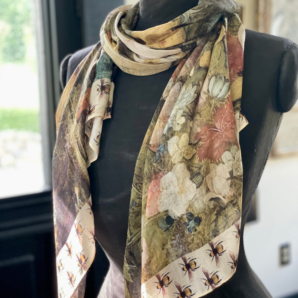 
                  
                    Model wearing the I Dream in Flowers Scarf featuring lush floral art by Jan Brueghel and charming Victorian bumblebees – Market of Stars.
                  
                