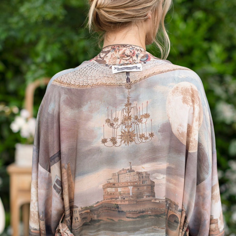 
                  
                    Model wearing the Imaginarium matinee duster featuring a dreamy collage of historic art, candle chandelier, and sleeping muse inspired by Victorian paintings – Market of Stars
                  
                